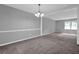 Carpeted dining room with classic chandelier and window with natural light at 3929 Emerald Springs Ct, Decatur, GA 30035
