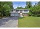 Charming split-level home with a brick facade, two-car garage, and well-manicured front yard at 3929 Emerald Springs Ct, Decatur, GA 30035