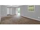 Living room featuring a sliding glass door and carpeted floor at 3929 Emerald Springs Ct, Decatur, GA 30035