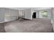 Bright open-concept living room with carpet and a staircase leading to the upper level at 3929 Emerald Springs Ct, Decatur, GA 30035