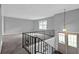 Open living space with carpet, gray walls, and stylish railings leading to the entryway at 3929 Emerald Springs Ct, Decatur, GA 30035
