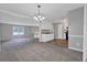 Spacious living area with carpet, a kitchen view, and neutral-toned walls for versatile decor at 3929 Emerald Springs Ct, Decatur, GA 30035