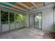 Screened-in porch with a view of lush greenery with a sliding door into an interior room at 3929 Emerald Springs Ct, Decatur, GA 30035