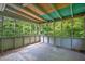 Screened porch features a wood ceiling, concrete floor, and expansive views of the backyard at 3929 Emerald Springs Ct, Decatur, GA 30035