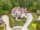 Aerial view of the property showcasing the home, manicured lawn, and surrounding trees at 1008 Stream Valley Ct, Alpharetta, GA 30022