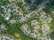 Drone image showcases a neighborhood with tree-lined streets and well-kept homes at 1008 Stream Valley Ct, Alpharetta, GA 30022