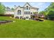 Spacious backyard featuring lush lawn, deck, and mature trees at 1008 Stream Valley Ct, Alpharetta, GA 30022