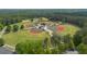Aerial view of well-maintained baseball fields with manicured lawns and trees at 1008 Stream Valley Ct, Alpharetta, GA 30022