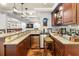 The wet bar features stone countertops, stainless steel appliances, and a sink, perfect for entertaining at 1008 Stream Valley Ct, Alpharetta, GA 30022
