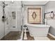 Bright bathroom features a frameless shower and soaking tub with stylish fixtures and decorative elements at 1008 Stream Valley Ct, Alpharetta, GA 30022