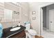 Stylish powder bathroom featuring a vanity with a black countertop and decorative wallpaper at 1008 Stream Valley Ct, Alpharetta, GA 30022