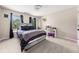 Comfortable bedroom includes a bed with light gray bedding, and a desk with chair at 1008 Stream Valley Ct, Alpharetta, GA 30022