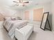 Bedroom featuring decorative headboard, ceiling fan, and neutral carpet at 1008 Stream Valley Ct, Alpharetta, GA 30022