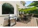 Outdoor deck featuring a grill and dining area with umbrella at 1008 Stream Valley Ct, Alpharetta, GA 30022