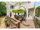 Outdoor patio with a large table and umbrella, perfect for enjoying meals outside at 1008 Stream Valley Ct, Alpharetta, GA 30022