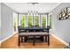 Bright dining room with views of the backyard featuring a large table and bench seating at 1008 Stream Valley Ct, Alpharetta, GA 30022