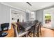 Dining room offers natural light and a view into the modern kitchen with white cabinets at 1008 Stream Valley Ct, Alpharetta, GA 30022