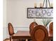 Close-up view of the dining room showcasing a wood table, seating, and elegant wall art at 1008 Stream Valley Ct, Alpharetta, GA 30022