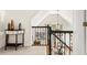 Hallway with a small decorative table and decorative railing at 1008 Stream Valley Ct, Alpharetta, GA 30022