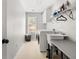 Well-lit laundry room boasts a sink, shelving, and modern washer and dryer for added convenience at 1008 Stream Valley Ct, Alpharetta, GA 30022