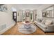 Cozy living room with soft lighting, neutral tones, and large windows bringing the outside in at 1008 Stream Valley Ct, Alpharetta, GA 30022