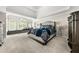 Spacious main bedroom features a large window seat, tray ceiling, and neutral colors for a relaxing retreat at 1008 Stream Valley Ct, Alpharetta, GA 30022