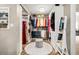 Well-organized walk-in closet with ample shelving, storage, and a central ottoman for added convenience at 1008 Stream Valley Ct, Alpharetta, GA 30022