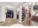 Spacious walk-in closet with custom shelving, cabinetry, and herringbone wood floors at 1008 Stream Valley Ct, Alpharetta, GA 30022