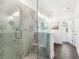 Luxurious shower with marble tiles and glass doors, featuring bench seating and modern fixtures at 1032 Robert Smalls Way, Atlanta, GA 30318