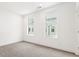 Bright bedroom features neutral carpet, white walls, and two windows allowing natural light at 1032 Robert Smalls Way, Atlanta, GA 30318