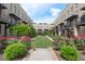 Community courtyard with manicured landscaping, grass, and flowering bushes at 1032 Robert Smalls Way, Atlanta, GA 30318