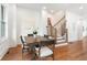 Dining room with hardwood floors, neutral wall decor, and view of staircase at 1032 Robert Smalls Way, Atlanta, GA 30318