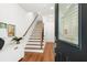 Bright entryway featuring hardwood floors, staircase with wooden railing, and modern decor at 1032 Robert Smalls Way, Atlanta, GA 30318