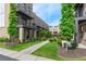 Charming brick townhomes with black metal balconies, lush landscaping, and inviting sidewalks at 1032 Robert Smalls Way, Atlanta, GA 30318