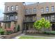 Charming brick townhouse featuring a private balcony and well-maintained landscaping at 1032 Robert Smalls Way, Atlanta, GA 30318