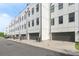 A long view of modern townhomes with attached garages, featuring a white exterior at 1032 Robert Smalls Way, Atlanta, GA 30318