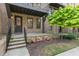 Brick townhome with front stoop and garden featuring seasonal plantings at 1032 Robert Smalls Way, Atlanta, GA 30318