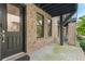 Close-up of brick townhome front porch with a black front door at 1032 Robert Smalls Way, Atlanta, GA 30318