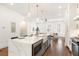 Bright kitchen featuring a large center island with marble countertops and stainless steel appliances at 1032 Robert Smalls Way, Atlanta, GA 30318