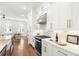 Close-up of a modern kitchen with white cabinets, stone countertops, and stainless steel appliances at 1032 Robert Smalls Way, Atlanta, GA 30318