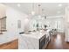Open kitchen with quartz countertops, island with bar seating and stainless steel appliances at 1032 Robert Smalls Way, Atlanta, GA 30318