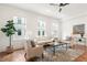 Bright living room featuring hardwood floors, a ceiling fan, and a comfortable seating arrangement at 1032 Robert Smalls Way, Atlanta, GA 30318