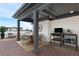 This rooftop patio features brick flooring, dining and grilling area, and a covered sitting area at 1032 Robert Smalls Way, Atlanta, GA 30318