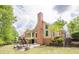 Backyard with patio seating and outdoor kitchen, offering an ideal space for relaxation and entertainment at 10610 Kingsmark Trl, Alpharetta, GA 30022