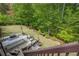 Outdoor kitchen featuring a built-in grill, bar seating, and patio furniture, perfect for entertaining in a backyard setting at 10610 Kingsmark Trl, Alpharetta, GA 30022
