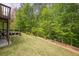 Expansive backyard with lush green grass, mature trees, and a private patio area for outdoor enjoyment at 10610 Kingsmark Trl, Alpharetta, GA 30022