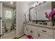 Bathroom features a granite countertop, white vanity, and modern fixtures at 10610 Kingsmark Trl, Alpharetta, GA 30022