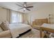 Bedroom with neutral colors, a ceiling fan, and a crib at 10610 Kingsmark Trl, Alpharetta, GA 30022