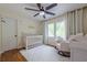 Light and airy Bedroom with hardwood floors, a crib, and a cozy rocking chair at 10610 Kingsmark Trl, Alpharetta, GA 30022