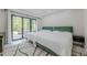 Bedroom featuring two beds, sliding glass doors leading to patio, and sleek modern design at 10610 Kingsmark Trl, Alpharetta, GA 30022